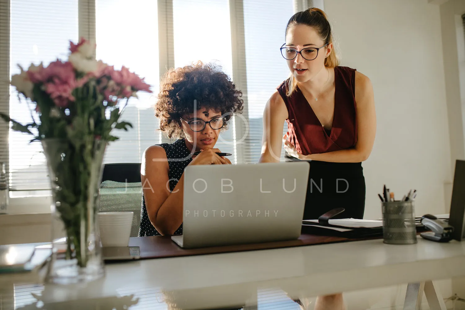 Business colleagues discussing working over a laptop