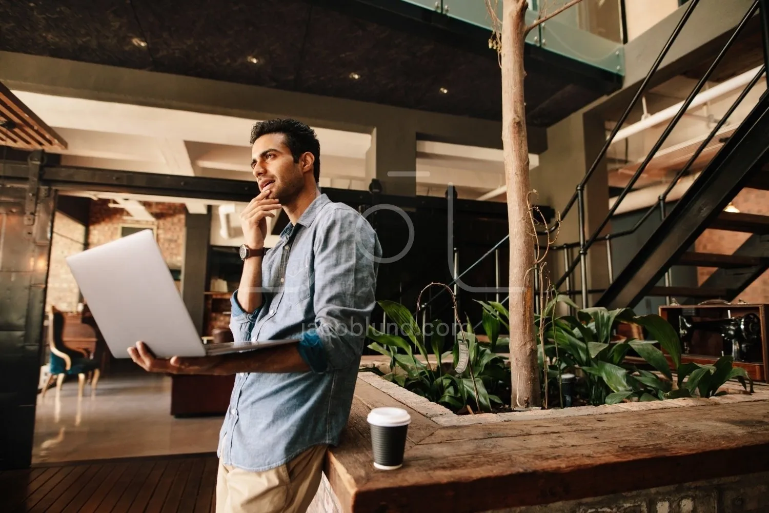 Business man thinking with laptop during break