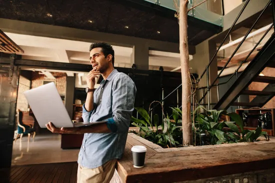 Business man thinking with laptop during break