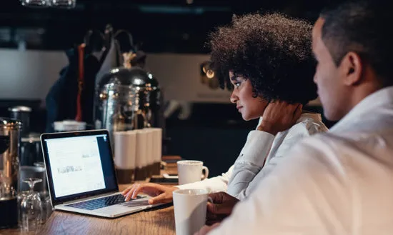 Business people working late on laptop